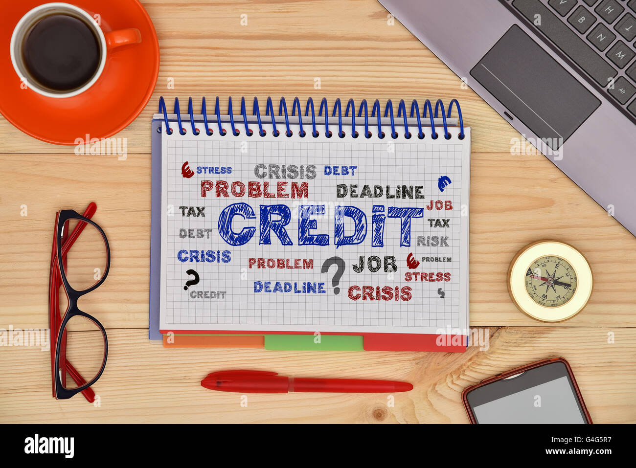Notebook with drawing credit concept and material office desktop on wooden desk, top view. Stock Photo
