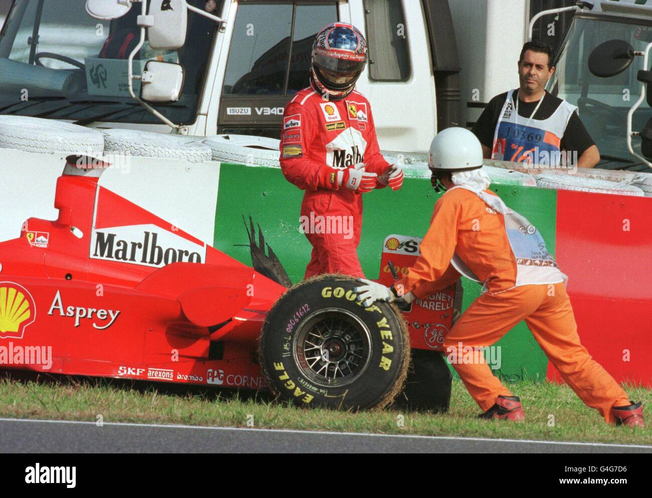 German F1 driver Michael Schumacher of Ferrari looks on at his bursted