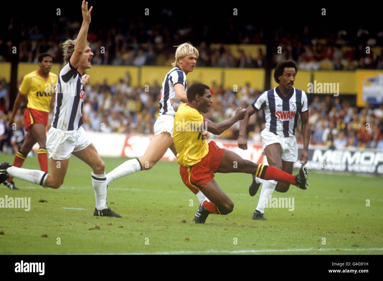 Watford's Luther Blissett (second r) fires home one of his two goals, watched by West Bromwich Albion's Ally Robertson (l), Martyn Bennett (second l) and Brendon Batson (r) Stock Photo