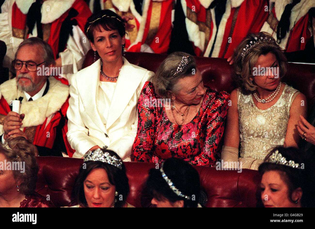 Hollywood actress Jamie Lee Curtis (second left), wife of Lord Hayden-Guest, sits in the House of Lords as the Queen makes her speech at the state opening of parliament. Stock Photo