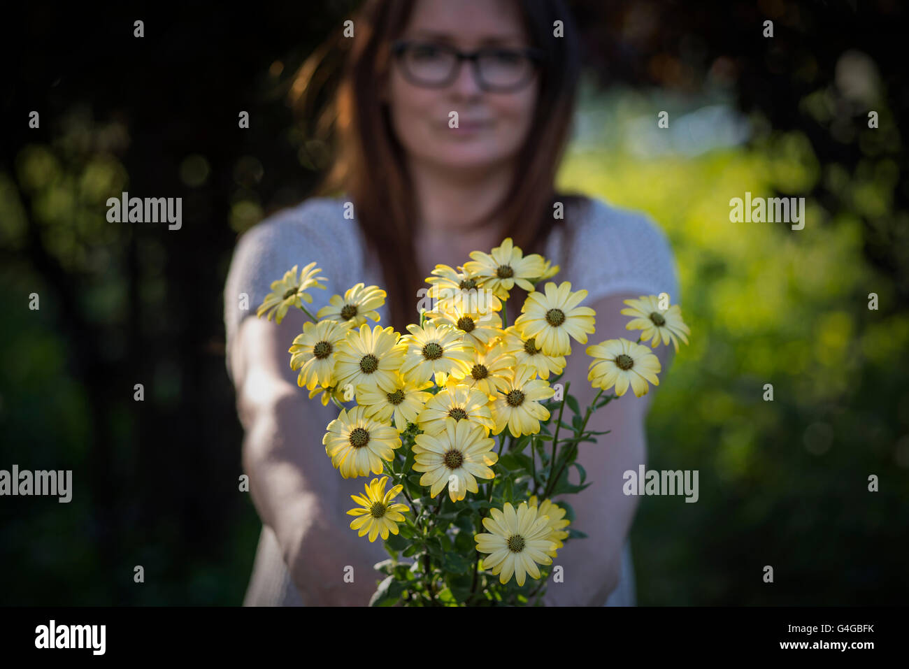 young woman with a bouquet of flowers Stock Photo
