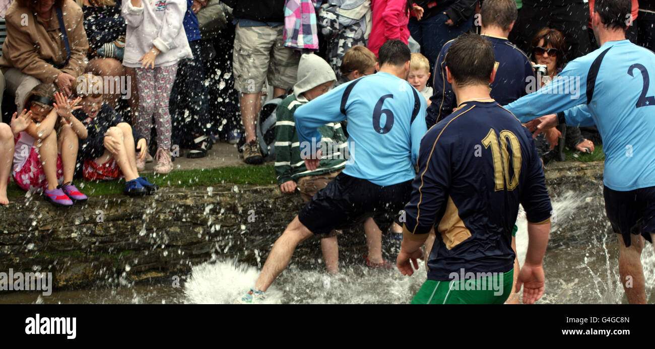 Two young children take cover from the water as Bourton Rovers 1st XI