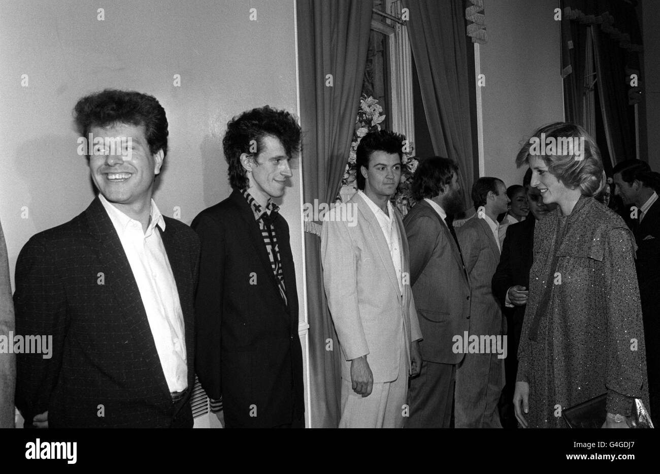 PA NEWS PHOTO 8/6/84  THE PRINCESS OF WALES GREETS POP STARS IN THE FOYET OF THE ROYAL ALBERT HALL IN LONDON BEFORE A POP CONCERT. FROM LEFT TO RIGHT: MARK PINDER, STEVE BOLTON AND PAUL YOUNG MEMBERS OF THE LEAD SINGER GROUP 'THE ROYAL FAMILY' Stock Photo