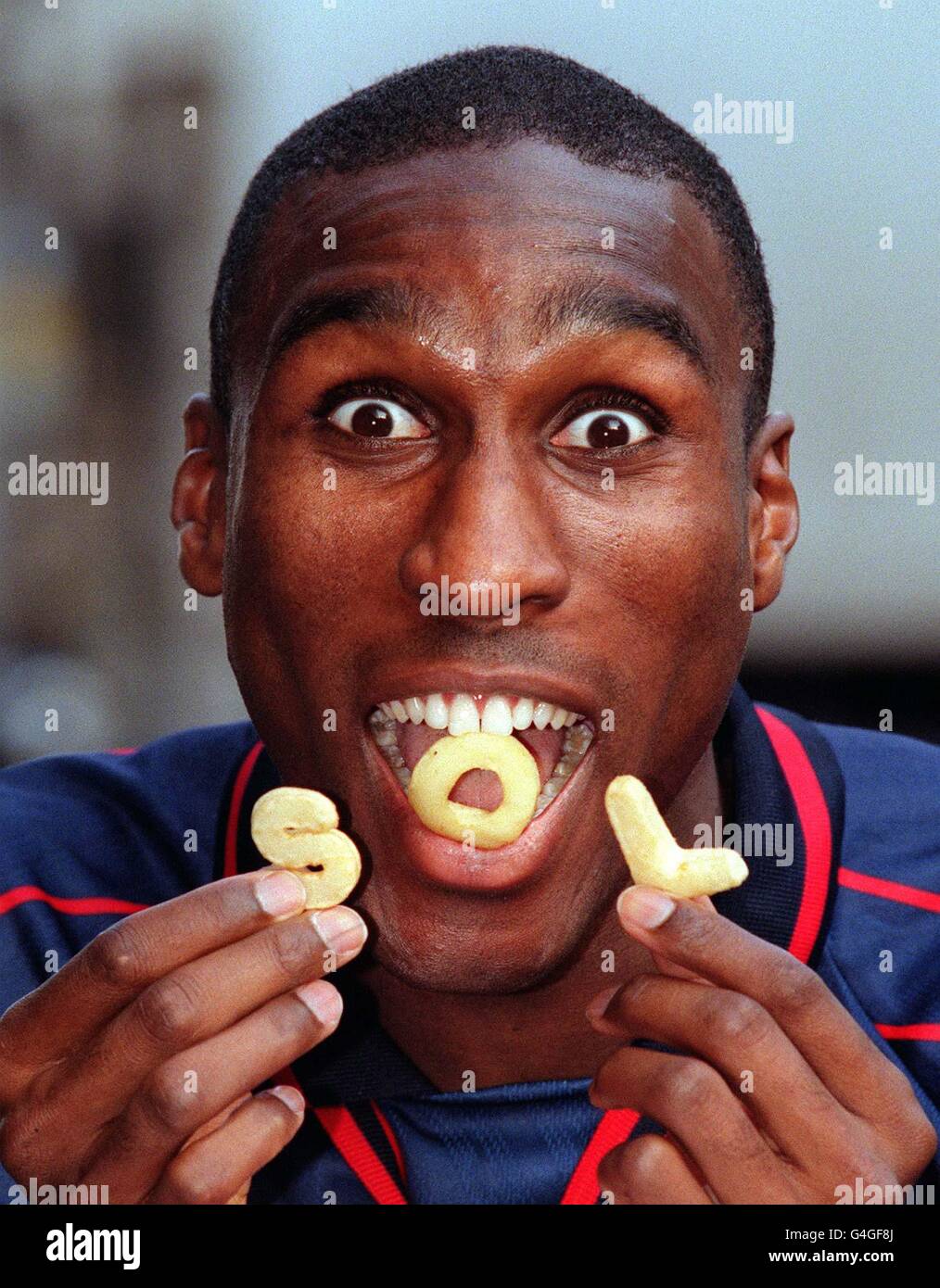 England soccer captain Sol Campbell eats his way through the first live edible football draw to select the 5th round line-up of the new schoolboy tournament, The Heinz Ketchup Cup at the Sports Cafe, Haymarket in London today (Wednesday). Photo by Peter J Jordan/PA. Stock Photo
