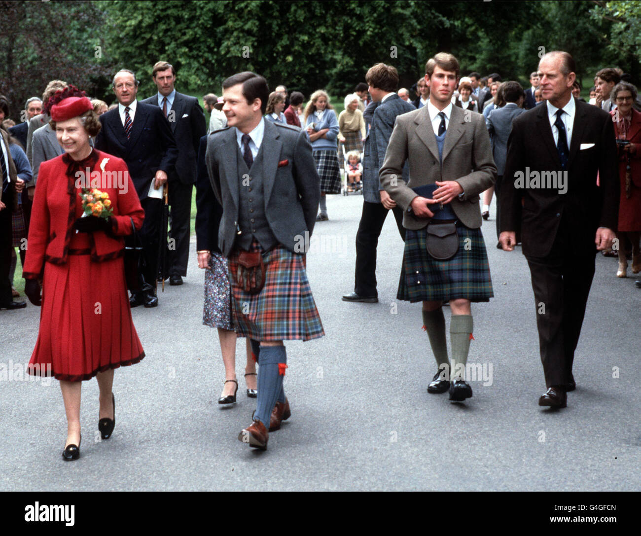 Queen Elizabeth II and the Duke of Edinburgh (right) walk in the grounds of Gordonstoun School with the school's Headmaster, Mr Michael Mavor (centre, left), and their youngest son, Prince Edward, the Head Boy and in his final term. Stock Photo