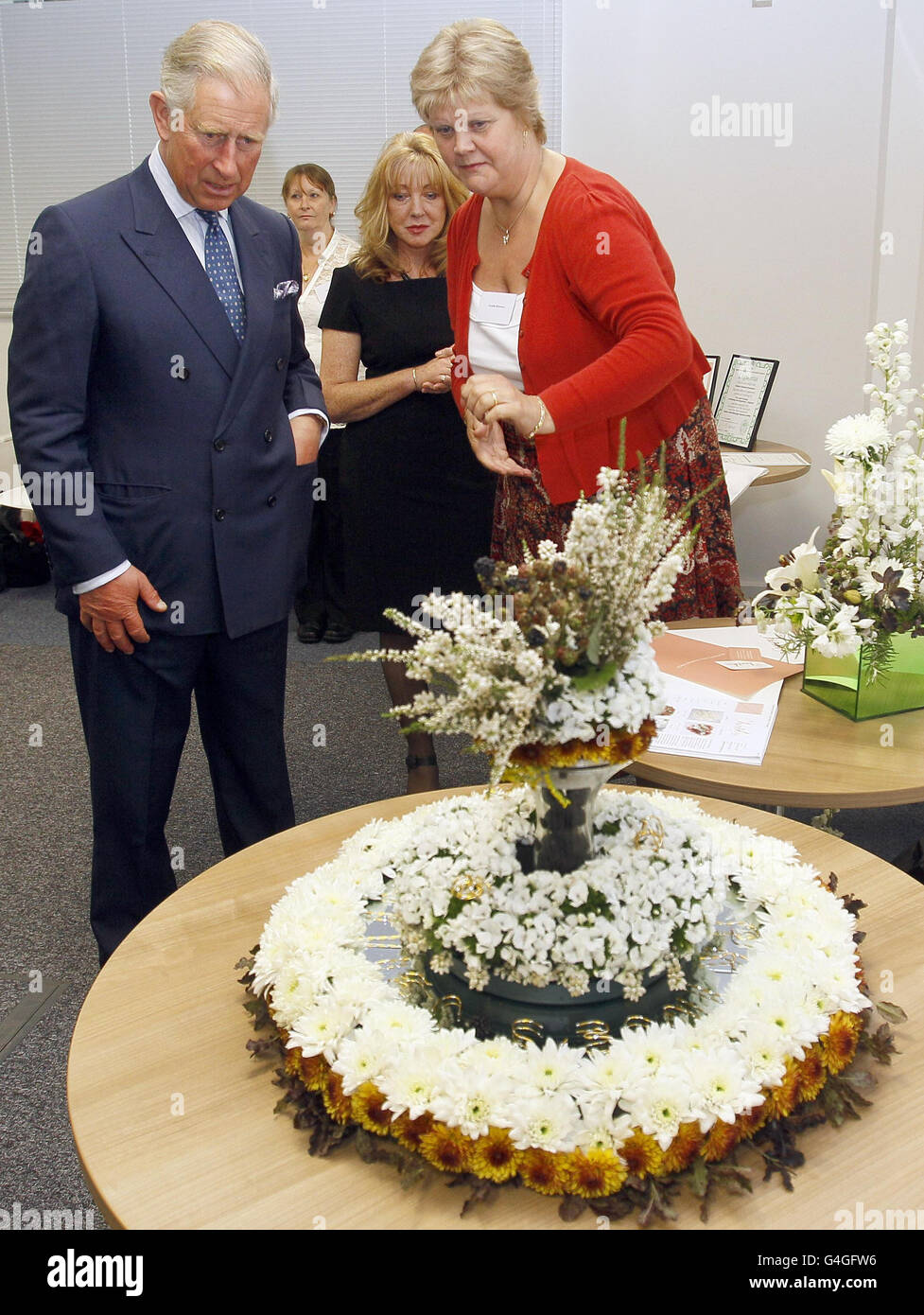The Prince of Wales is shown a floral design by florist Annette Molyneux from Cornwall, at Tavis House in London. Stock Photo