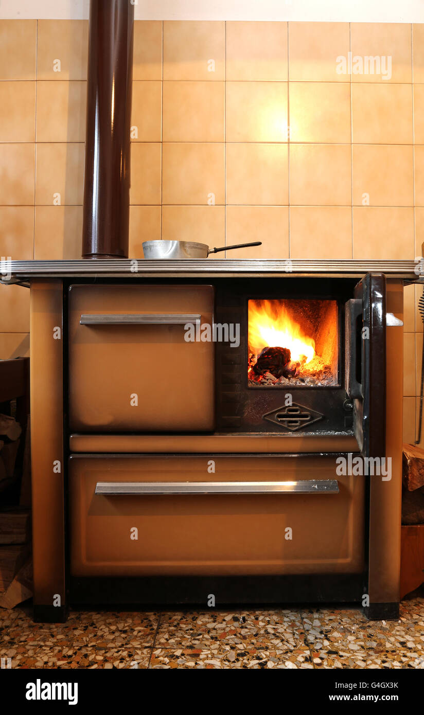 wood-burning stove in the kitchen of mountain home Stock Photo