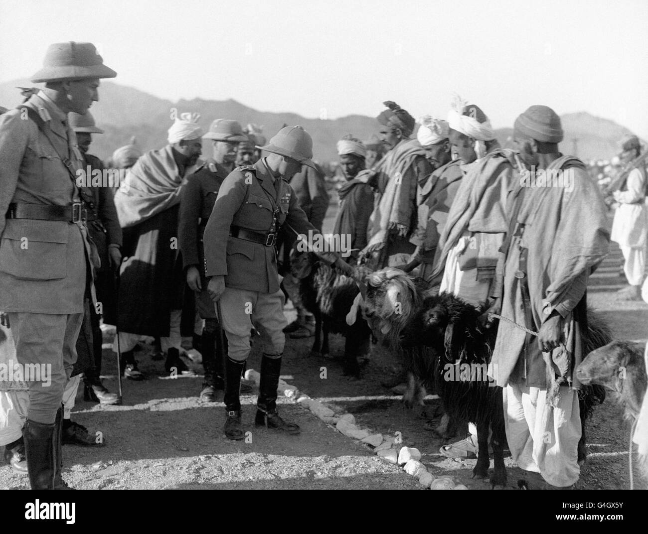 The Prince of Wales receives a gift of sheep presented by the Maliks of the Khyber Agency during his visit to the Khyber Pass at Sarkai Shiga; part of his tour to Japan and the East. The Khyber Pass formed the main crossing point between British India and Afghanistan. Stock Photo