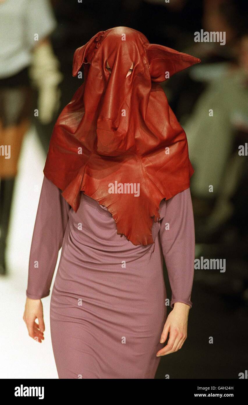 A model wears a leather pigs head mask, part of a collection by Adam Entwisle on the catwalk during a fashion show given by the Central Street Martin's school of Art. The 39 designers formed the last show of London Fashion Week. Stock Photo