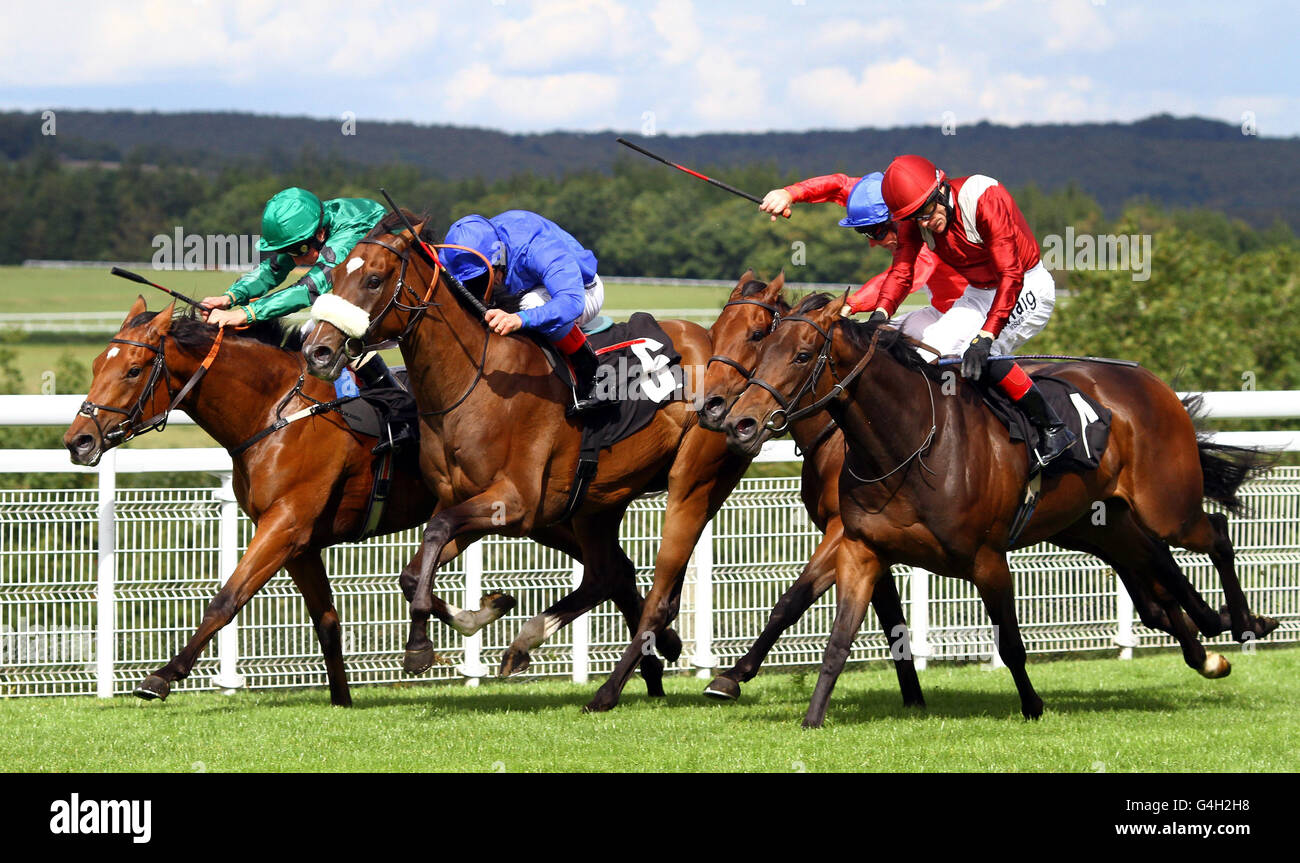 (Left to right) Questing ridden by William Buick, Rakasa ridden by Frankie Dettori, Regal Realm ridden by Jimmy Fortune and Nayarra ridden by Kieron Fallon, race for a photo finish at Goodwood Racecourse, Chichester. Stock Photo