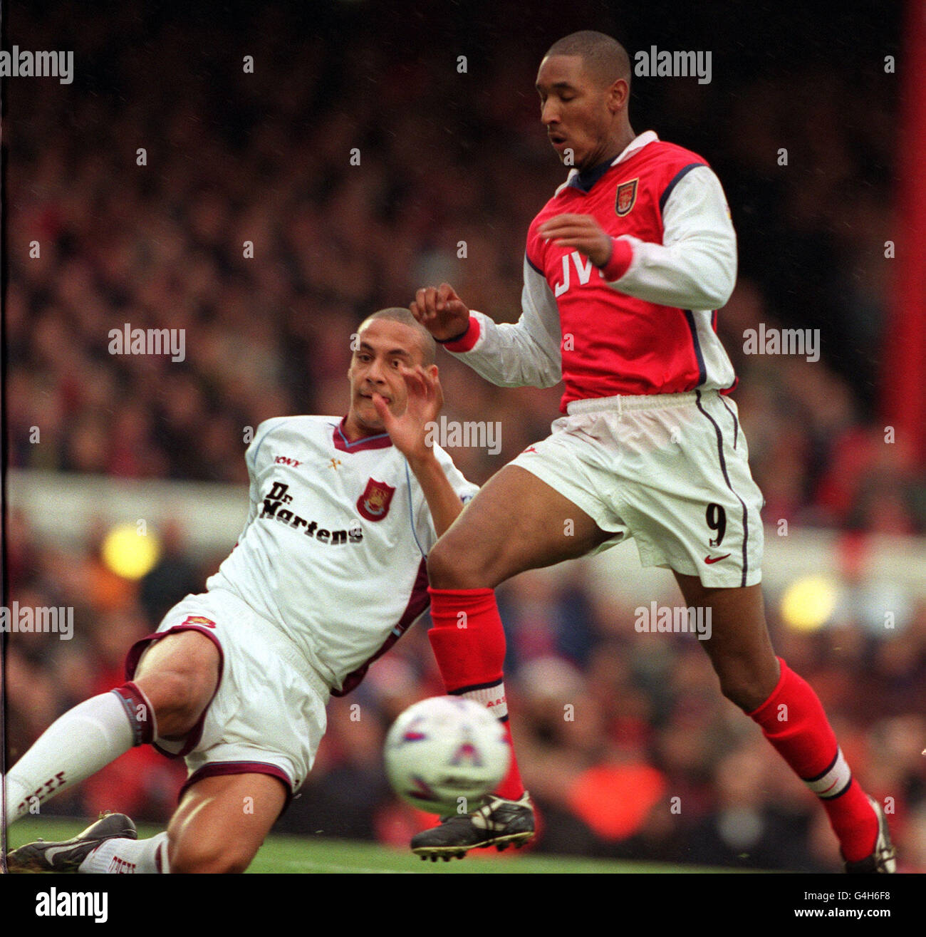 Arsenal's Nicolas Anelka evades a tackle from West Ham United's