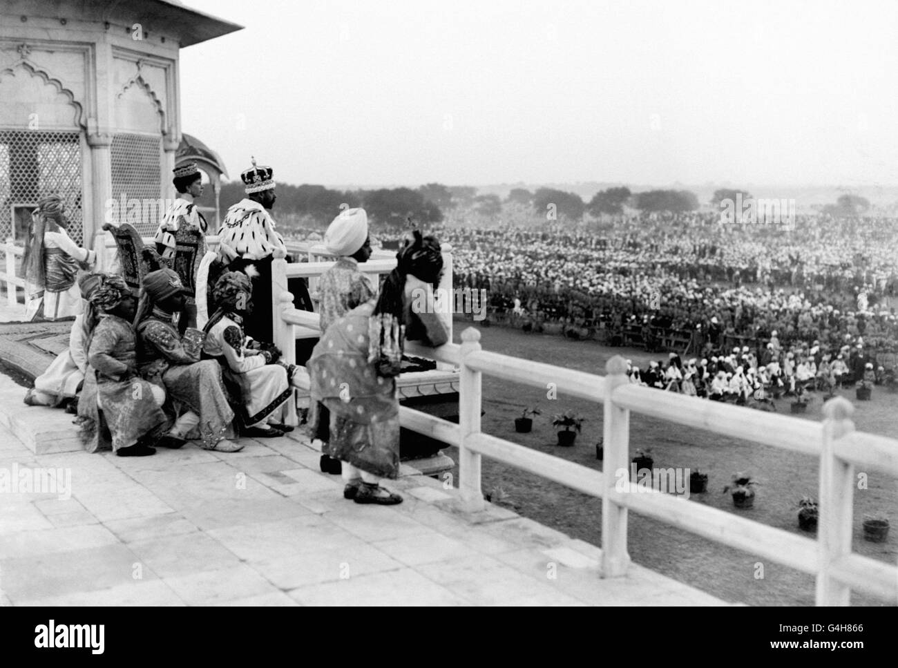 The new Emperor and Empress of India, King George V and Queen Mary, look down on their subjects from a balcony during the Delhi Durbar of December 1911. The King also announced the founding of New Delhi to replace Calcutta as the capital of British India. Stock Photo