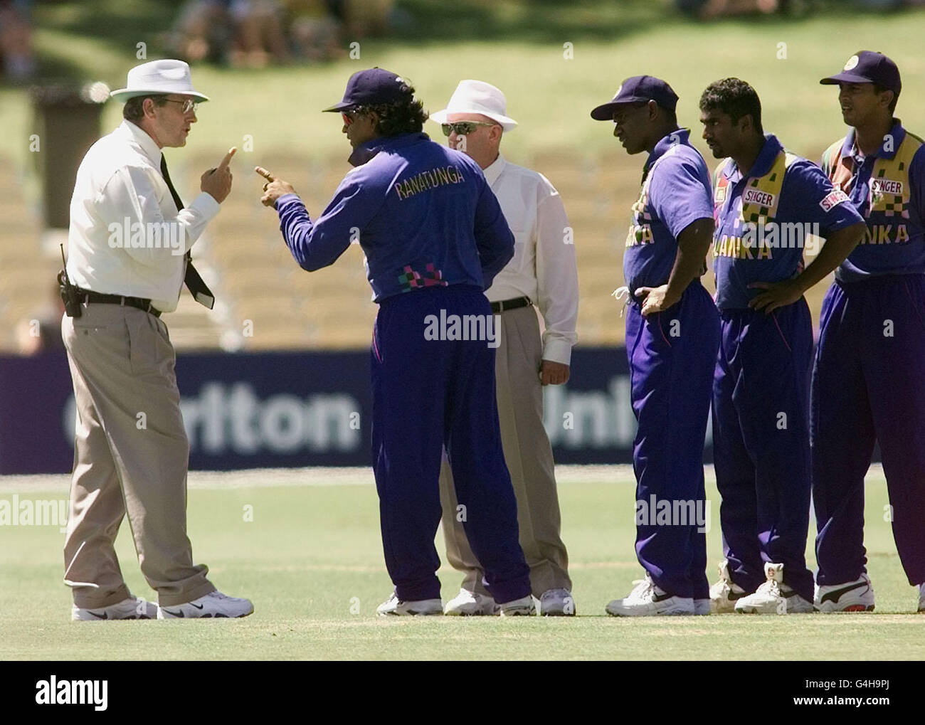 Sri Lankan Captain Arjuna Ranatunga (2nd left) engages in heated discussion with umpires Ross Emerson (left) and Anthony McQuillan after bowler Muttiah Muralitharan (2nd right) was called for chucking in a one-day match against England at the Adelaide Oval. * 28/1/99: Ranatunga fined 75% of match fee and given six-month suspended sentence by ICC disciplinary panel over incident. Stock Photo