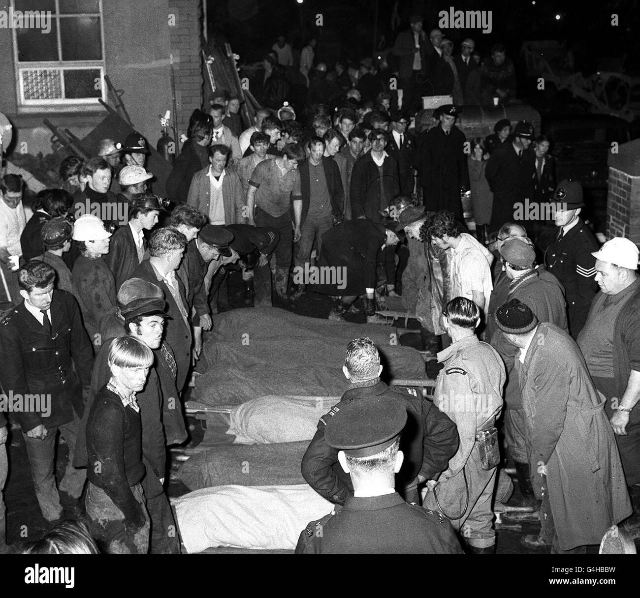 Surrounded by rescue workers and sorrowing villagers, blanket-covered bodies of children are lined up on stretchers outside Pantglas Junior School, Aberfan, Glamorganshire. Many of the school's pupils died when the village was struck by thousands of tons of coal dust and earth which avalanched down from a colliery tip. Stock Photo