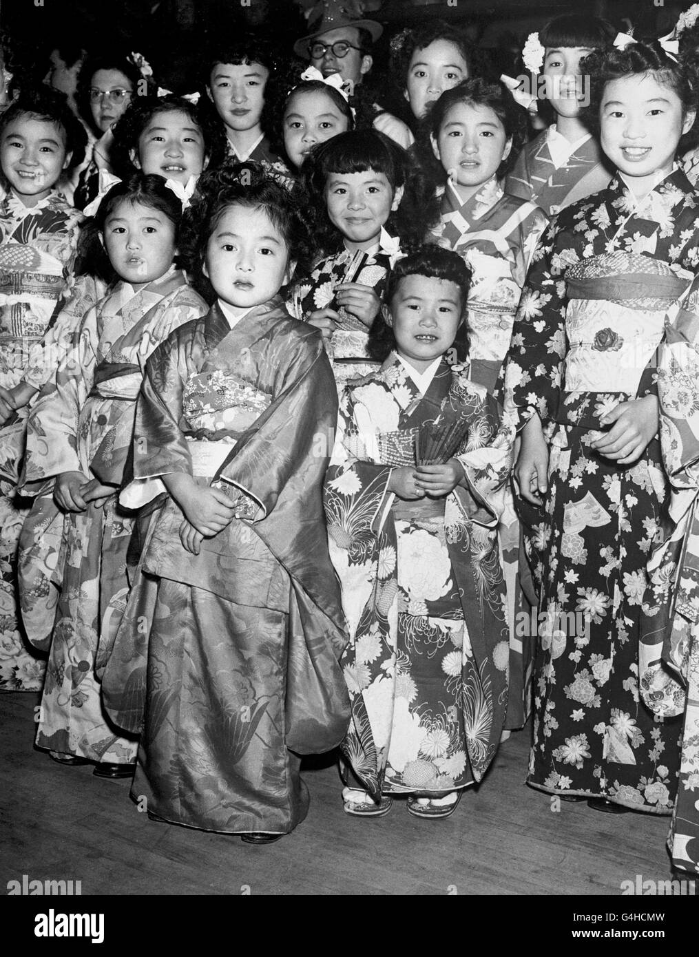 Young Japanese Canadians wearing the traditional costume of their ancestral home as they join in the welcome to Princess Elizabeth and the Duke of Edinburgh at Vancouver, during the royal tour of Canada. Stock Photo