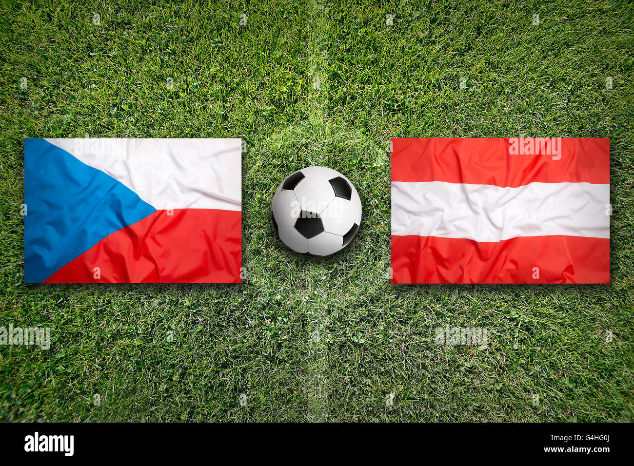 Czech Republic vs. Austria flags on green soccer field Stock Photo