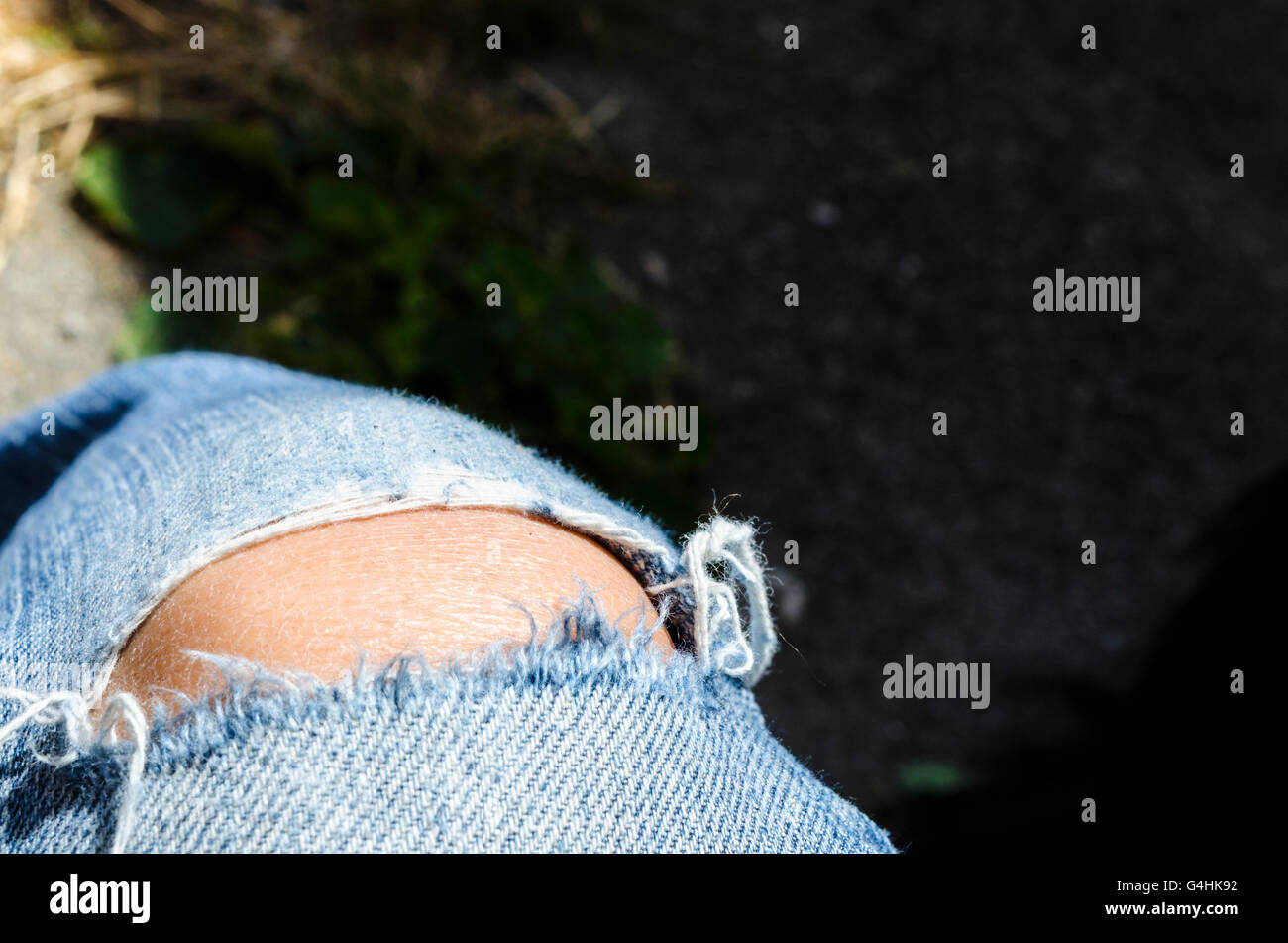 Jeans with a blown out knee Stock Photo