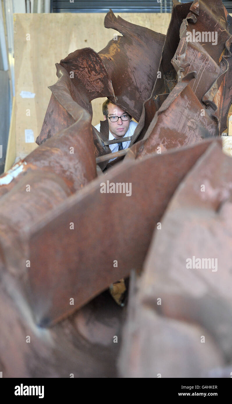Alex Knight looks at a section of steel from the wreckage of the 9/11 attack on New York's World Trade Centre twin towers, believed to be from the North Tower, on display at the Imperial War Museum (IWM) North in Manchester. Stock Photo