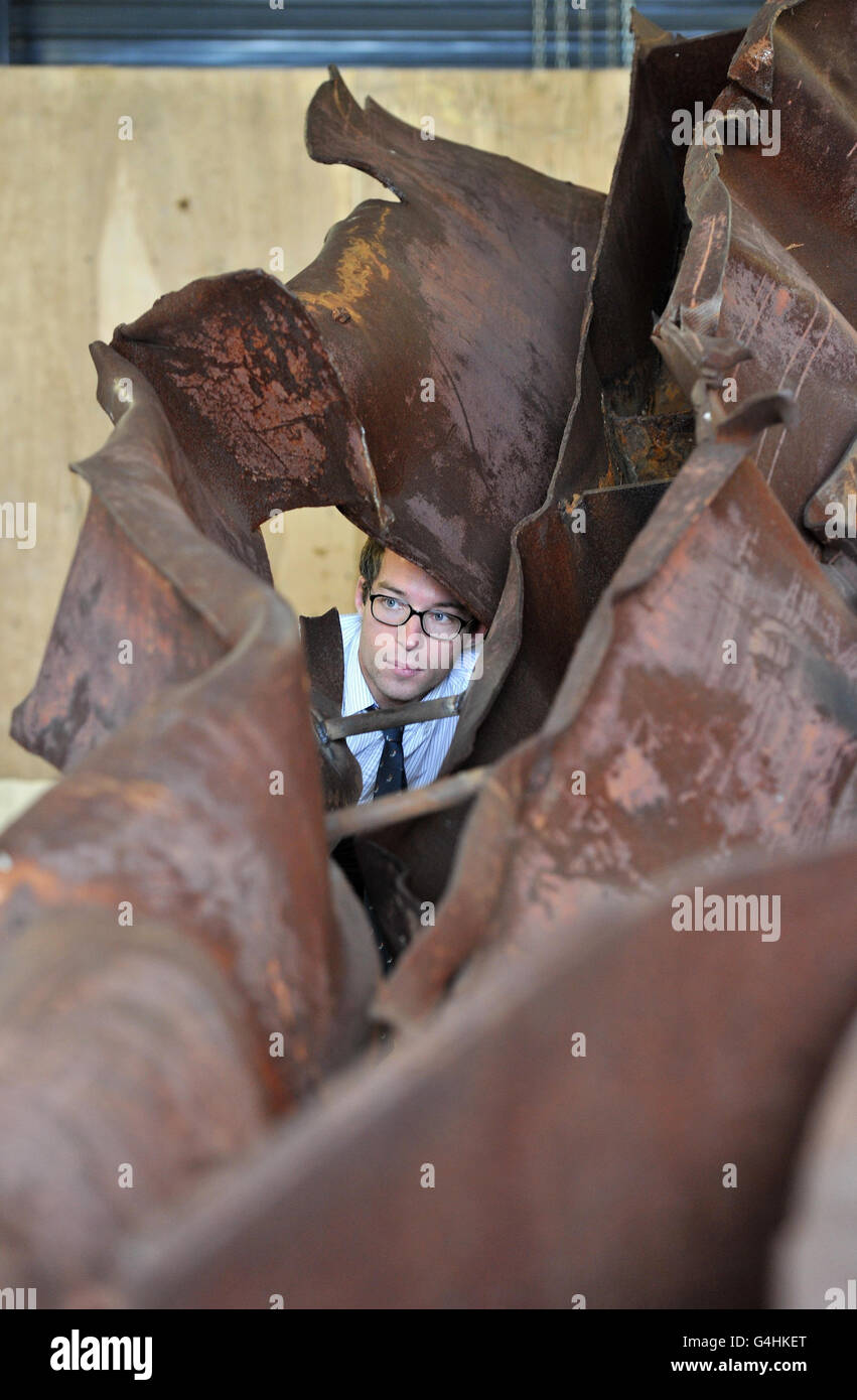 Alex Knight looks at a section of steel from the wreckage of the 9/11 attack on New York's World Trade Centre twin towers, believed to be from the North Tower, on display at the Imperial War Museum (IWM) North in Manchester. Stock Photo