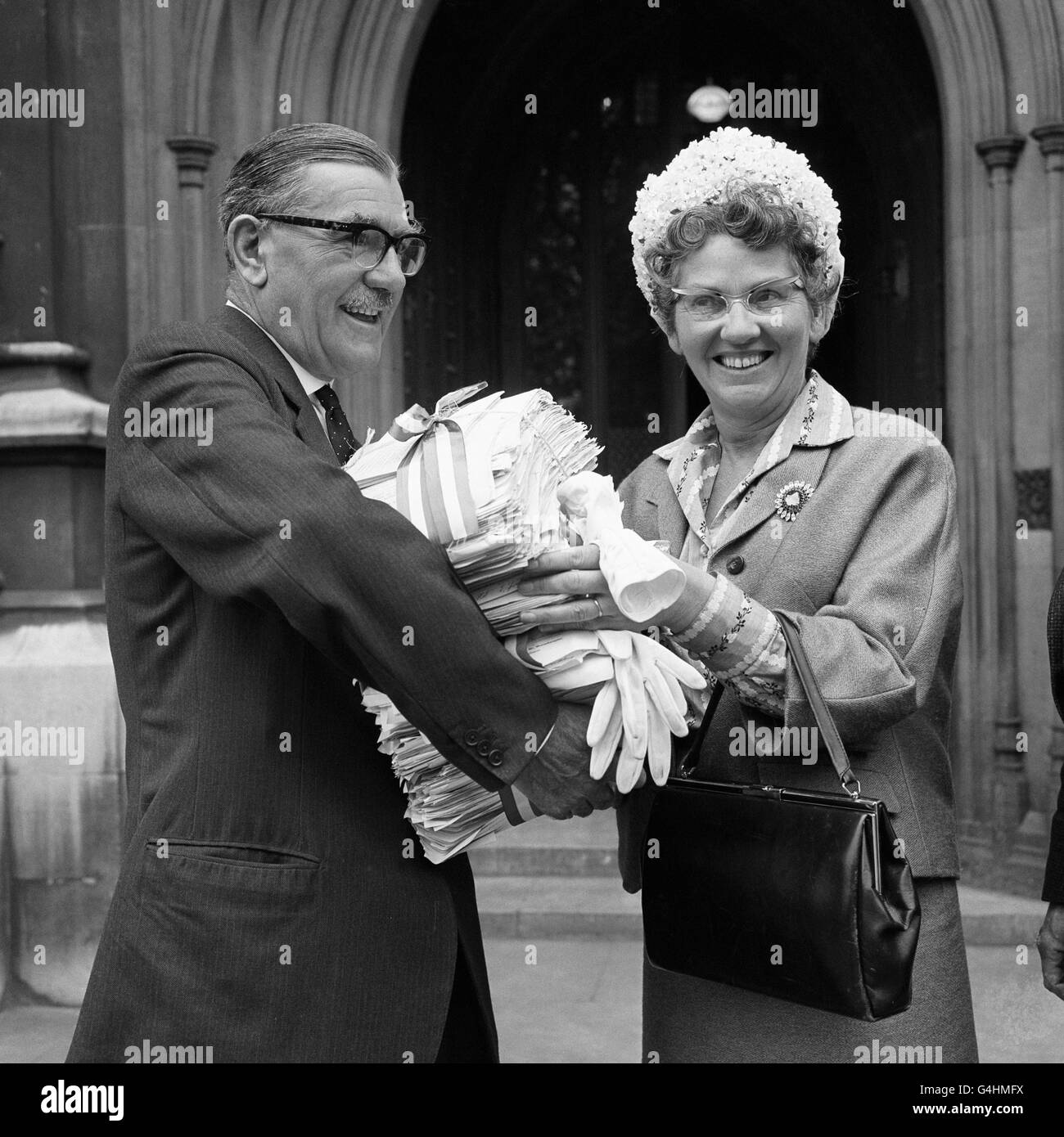 Mrs Mary Whitehouse hands to James Dance, Conversative MP for Bromsgrove, bundles containing 366,355 signatures in support of a petition praying 'that the BBC be asked to make a radical change of policy and produce programmes which build character...' * instead of destroying it...'. Stock Photo