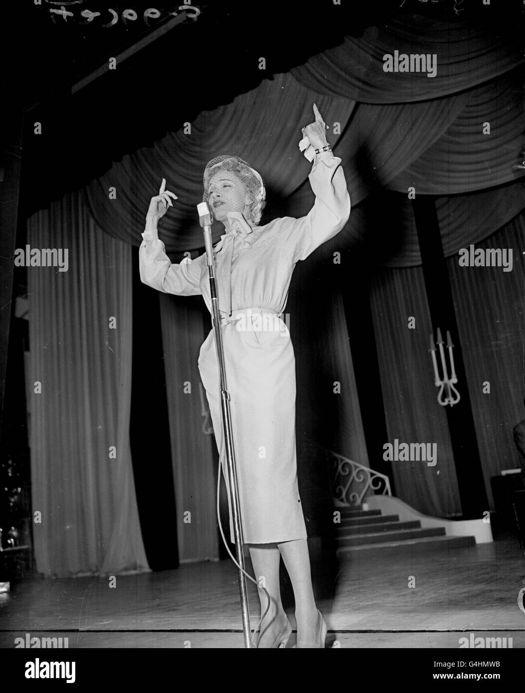Marlene Dietrich on the stage of the London Palladium as she rehearses for 'Night of 100 stars', the day before the show, in which Ms Dietrich is to appear, opens. She is pictured performing in a midnight revue held in aid of the Actors' Orphanage. Stock Photo