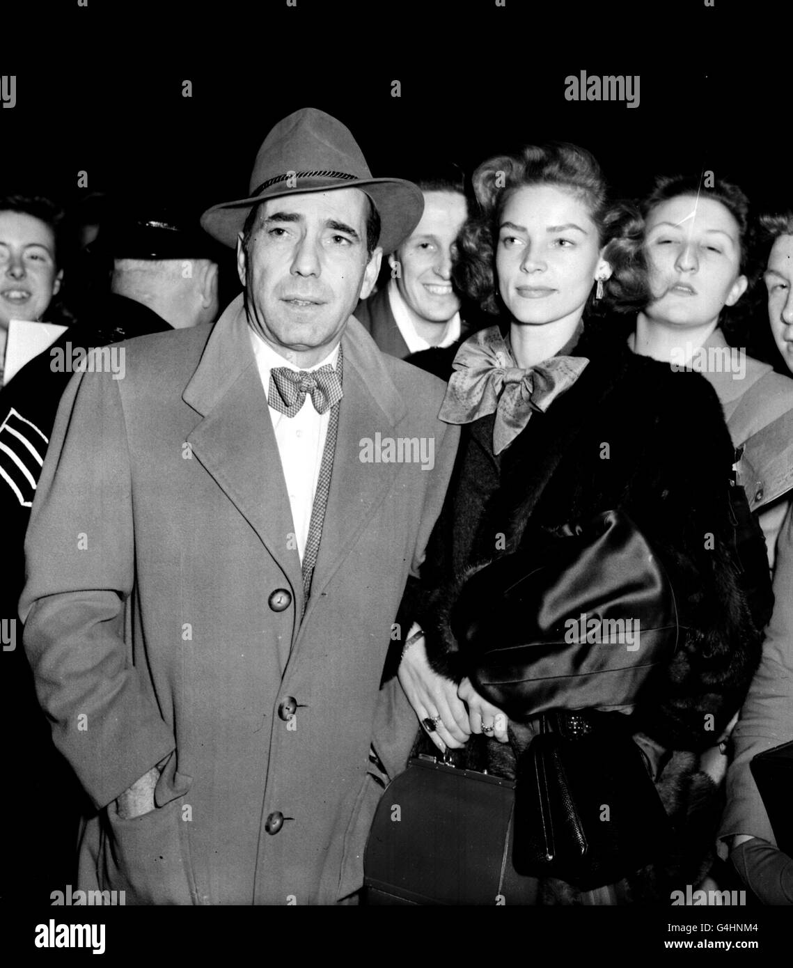 Hollywood stars, husband and wife, Humphrey Bogart and Lauren Bacall on arrival at Victoria Station in London. Bogart was to make his British screen debut in 'The African Queen', to be filmed in Britain and Africa. Stock Photo