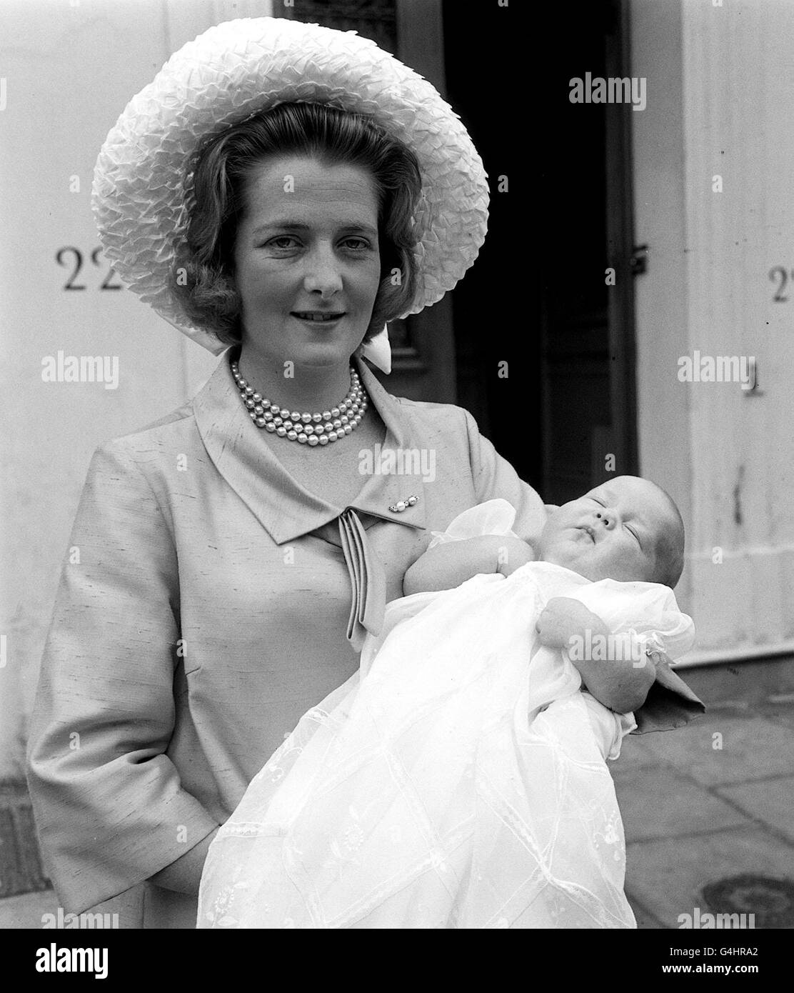 PA NEWS PHOTO 14/7/64 LADY ALTHORP, WIFE OF VISCOUNT ALTHORP PICTURED WITH THEIR SON, BORN AT THE LONDON CLINIC ON 20TH MAY, BEFORE LEAVING A LONDON ADDRESS FOR THE CHRISTENING CEREMONY AT WESTMINSTER Stock Photo