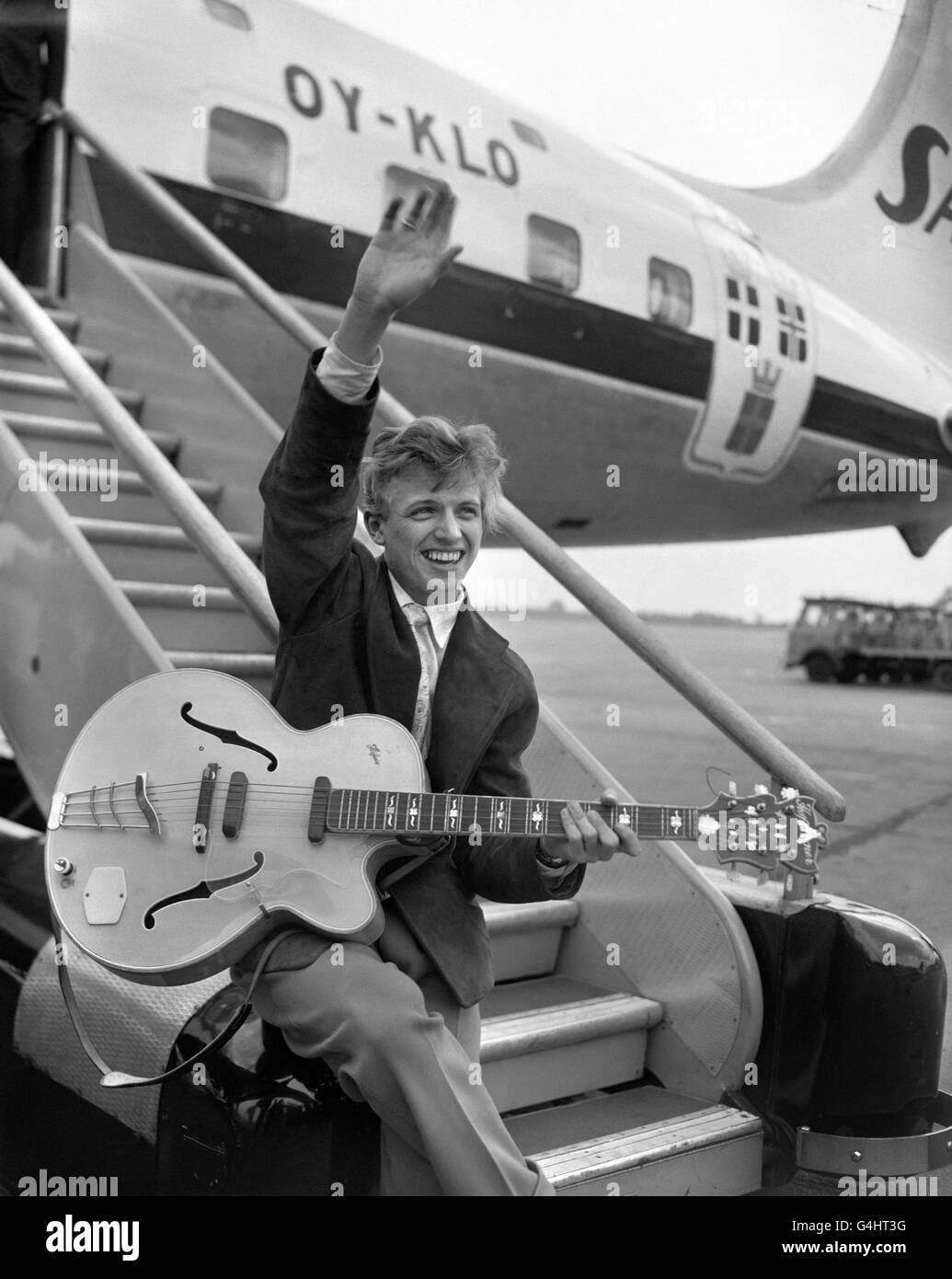 Tommy Steele at London Airport before leaving for Copenhagen at the start of a two week personal appearance tour, which will also move him onto Stockholm, Oslo, Hamburg and Brussels. The visits are in connection with the opening of his new film ' The Tommy Steele Story' in those cities. Stock Photo