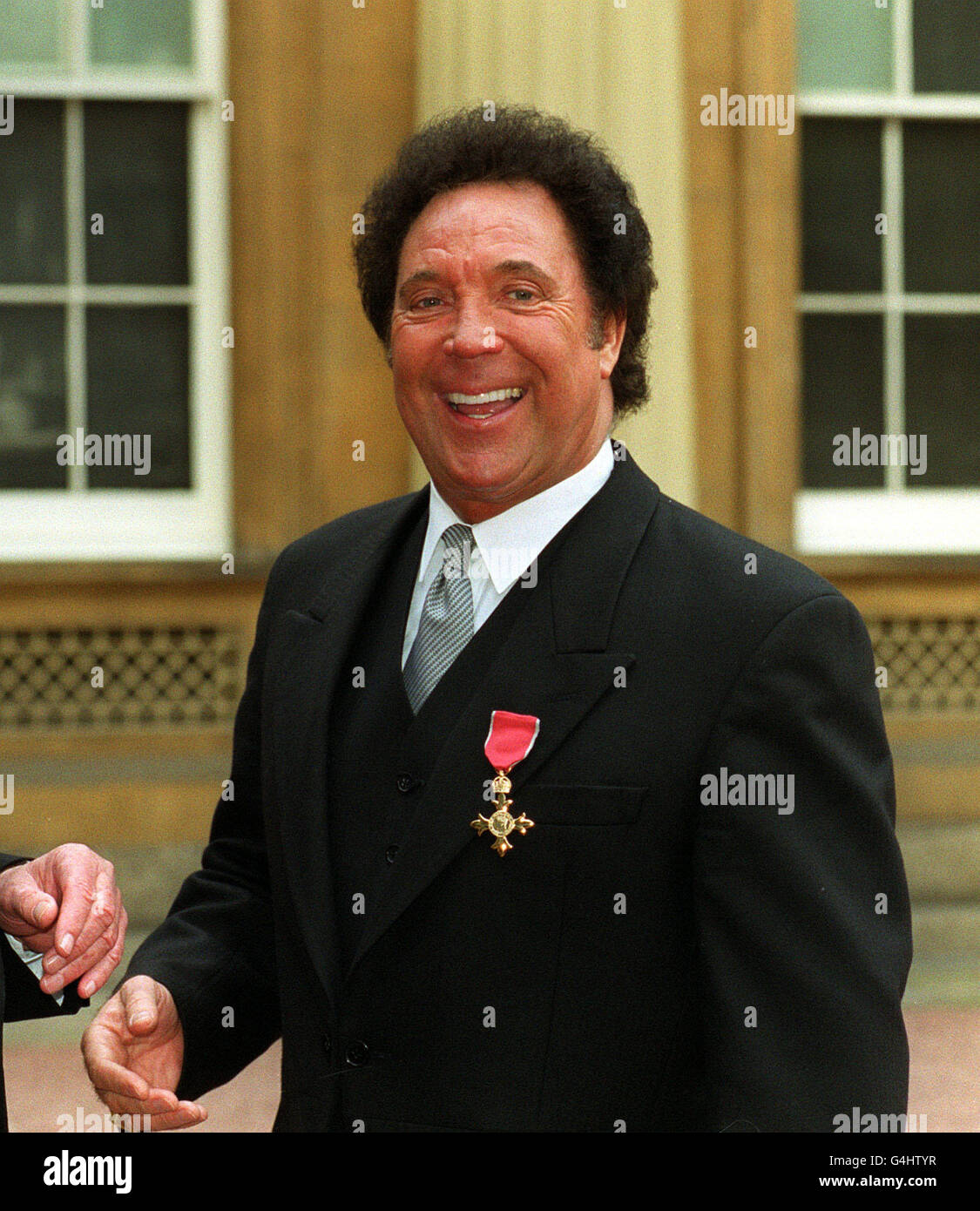 Welsh singer Tom Jones at Buckingham Palace in London after he received an OBE (Order of the British Empire) from the Queen. Stock Photo