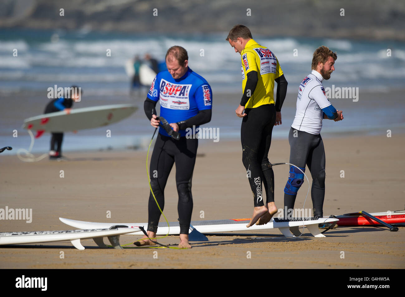 Competitors in the BSUPA stand up paddle board competition doing warm up exercises before their