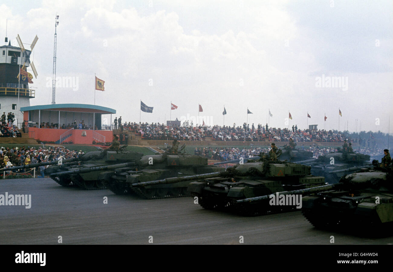 Tanks rumble past the dais with guns dipped in salute during the Silver Jubilee Review of the British Army of the Rhine by Queen Elizabeth II at Sennelager, West Germany. Stock Photo