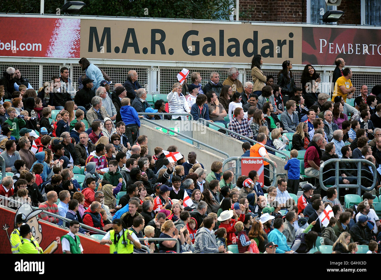 Fans watch the action at the Kia Oval in front of M.A.R Galadari signage Stock Photo