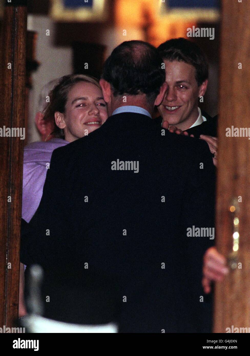 The Prince of Wales bids farewell to Camilla Parker Bowels' children, Laura (left) and Tom before he leaves the Ritz Hotel in London after attending the 50th birthday party of Camilla's sister, Annabel Elliott. Stock Photo