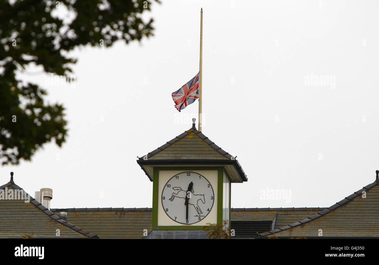 A flag on the Queen Mother Stand flies at half mast at Aintree