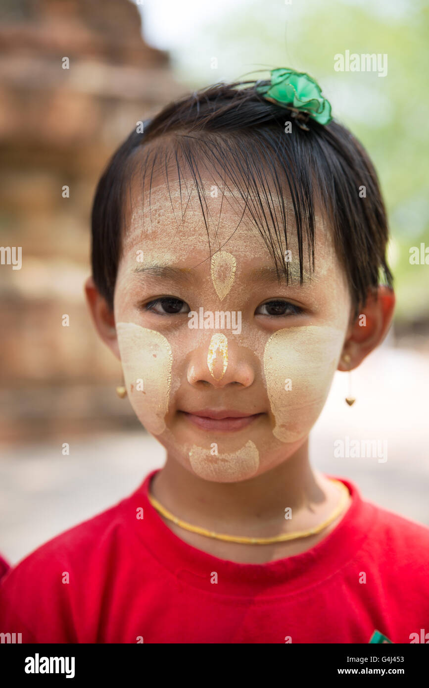 Young girl with thanaka paste on her face, Old Bagan Archaelogical Zone, Mandalay Region, Myanmar Stock Photo