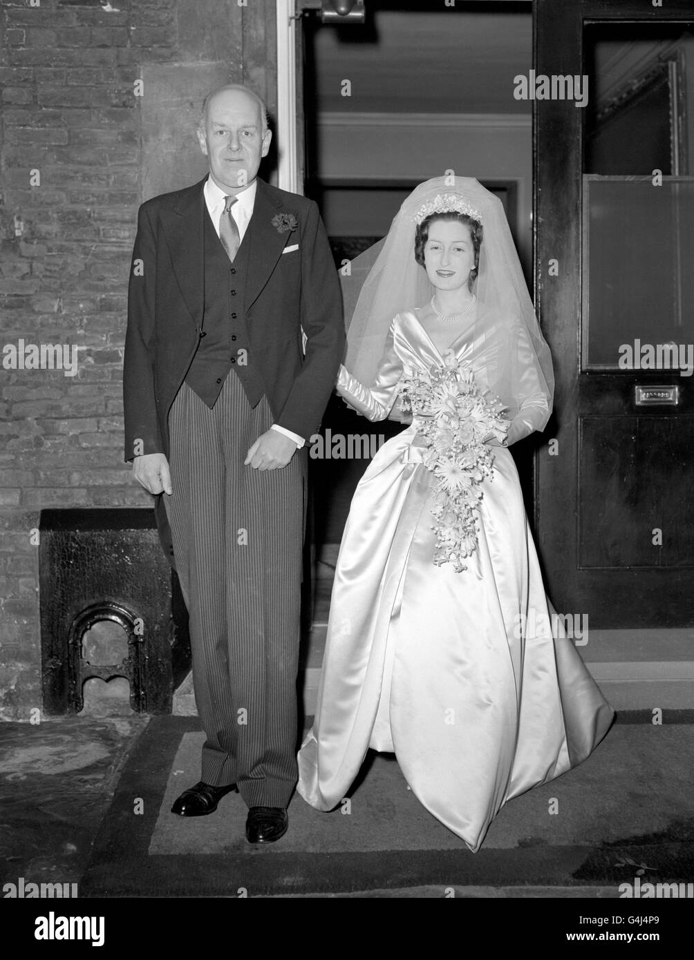 Miss Diana Cinderella Bowes-Lyon, 36, and her bridegroom Peter Gordon Somervell, arrive at St James' Palace for the reception after their wedding at Westminster Abbey. Stock Photo