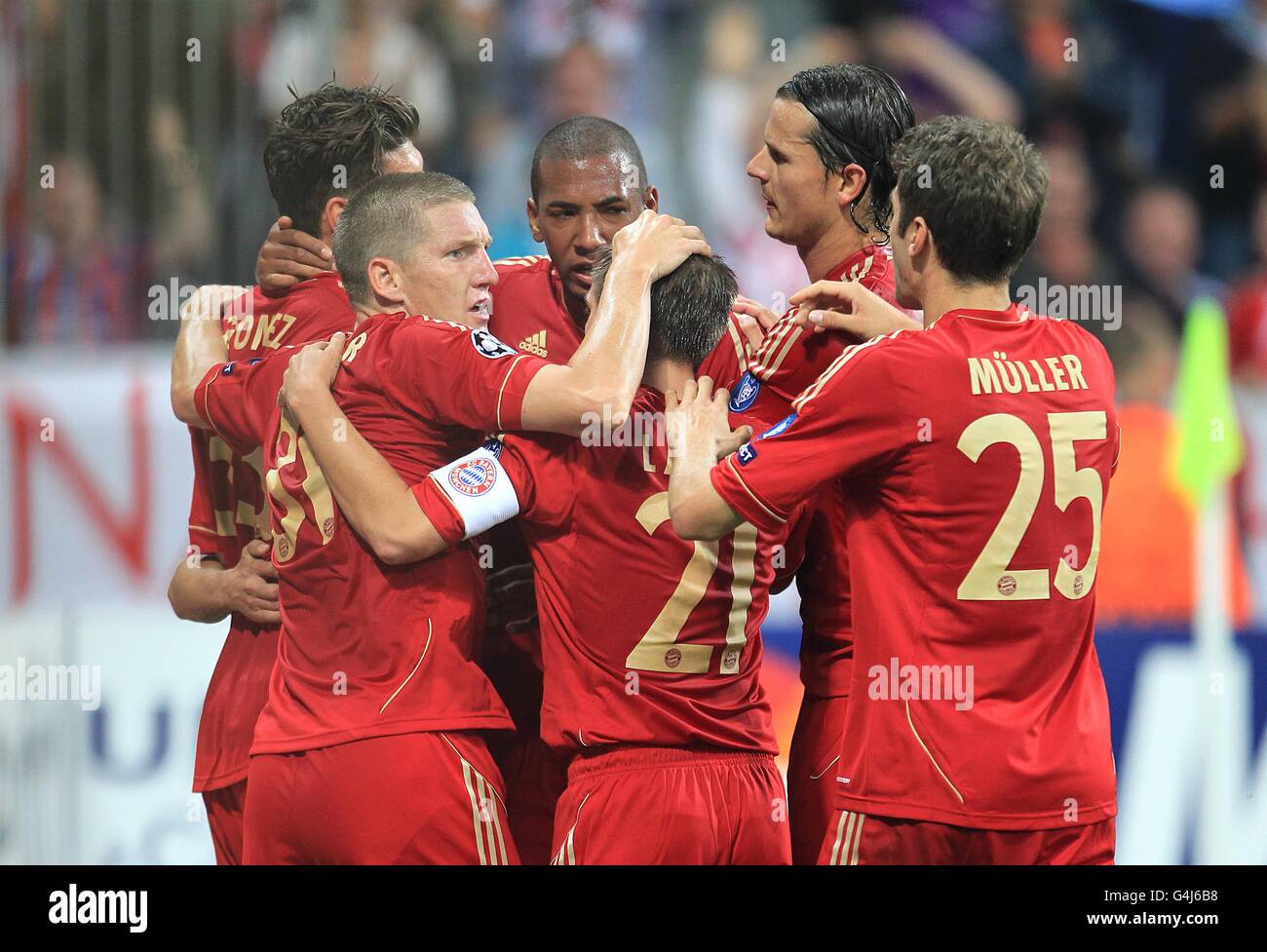 Bayern Munich's Mario Gomez (hidden left) is congratulated by his team mates after scoring Stock Photo