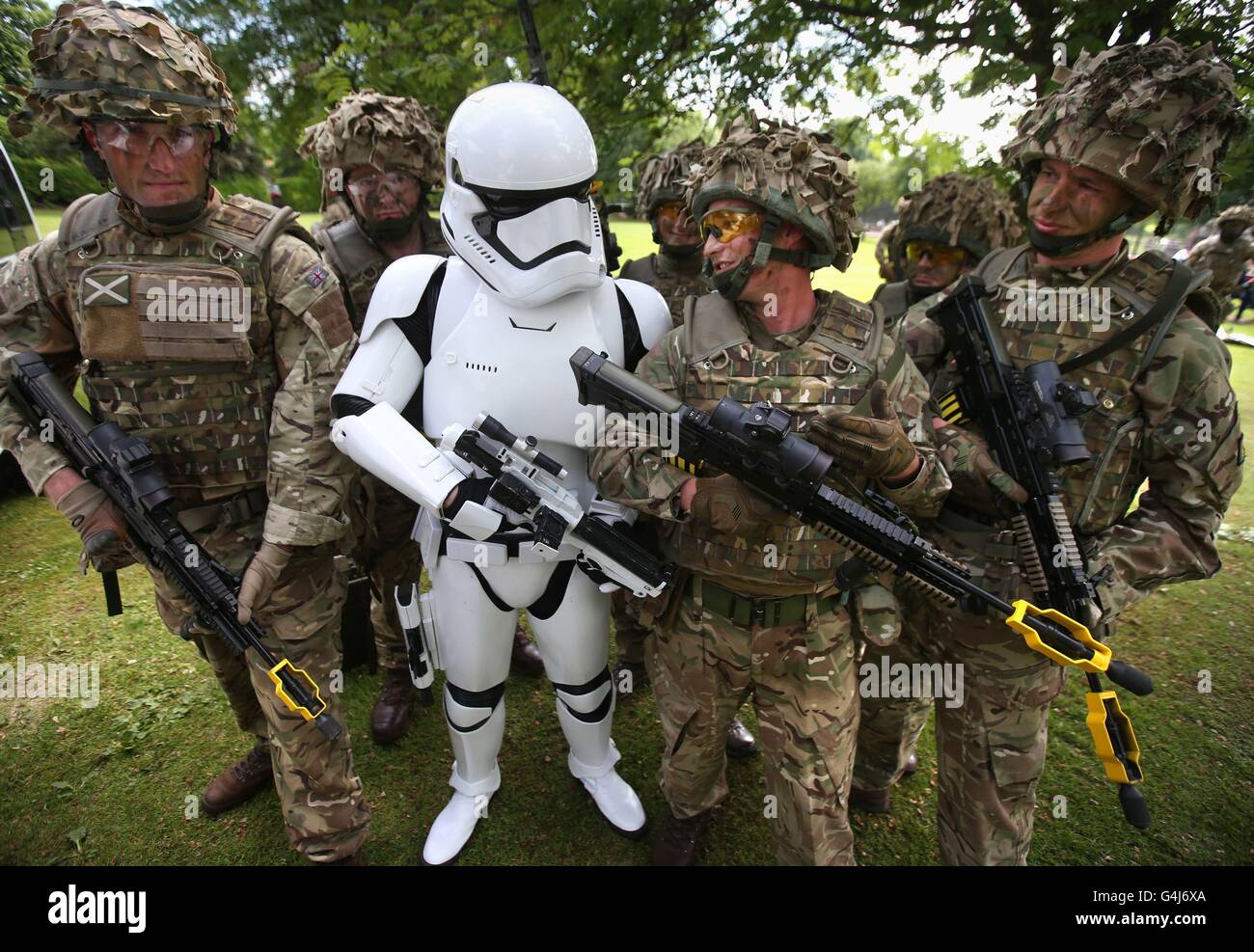 A stormtrooper discusses weaponry with soldiers from 7 SCOTS Royal Regiment of Scotland during the Stirling Military Show at Kings Park, Stirling. Stock Photo