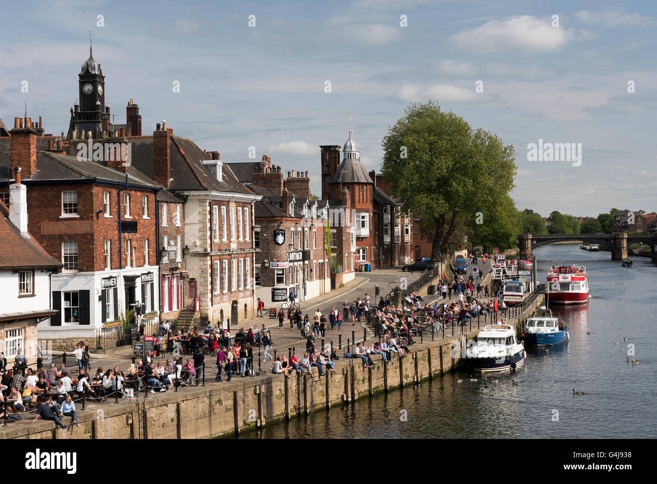 View over River Ouse and King's Staith with people enjoying a drink outside riverside pubs - York, North Yorkshire, England. Stock Photo