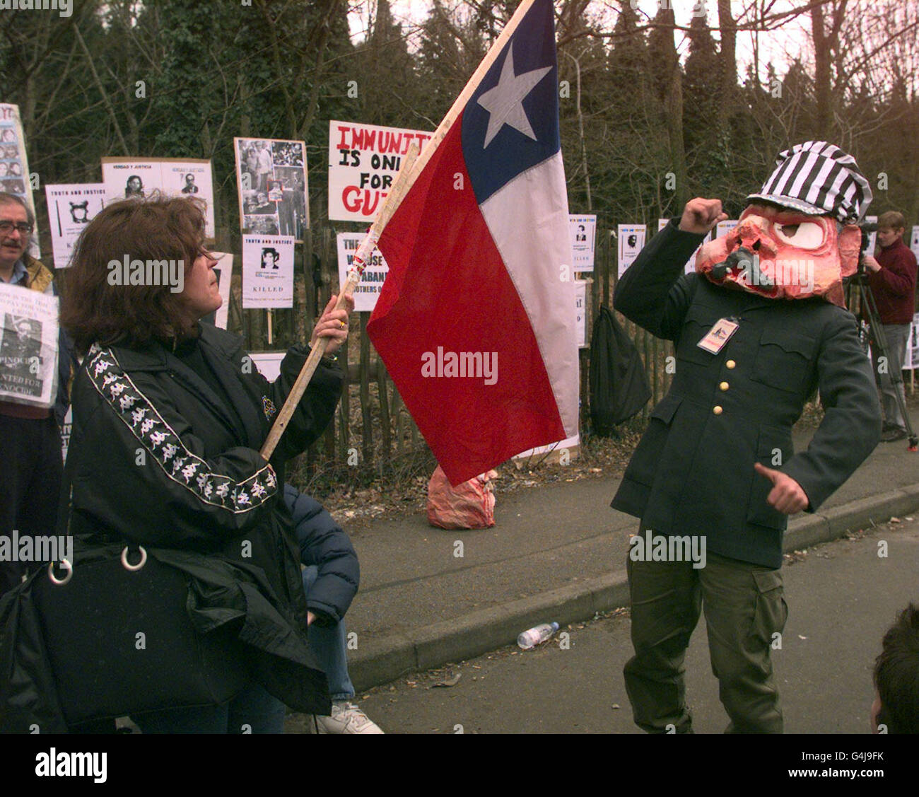 Anti Pinochet protesters outside the house in Wentworth, where former Chilean dictator General Augusto Pinochet is under house arrest, on the day that the House of Lords will rule whether Pinochet will be extradited to Spain to face trial for crimes against humanity. Stock Photo