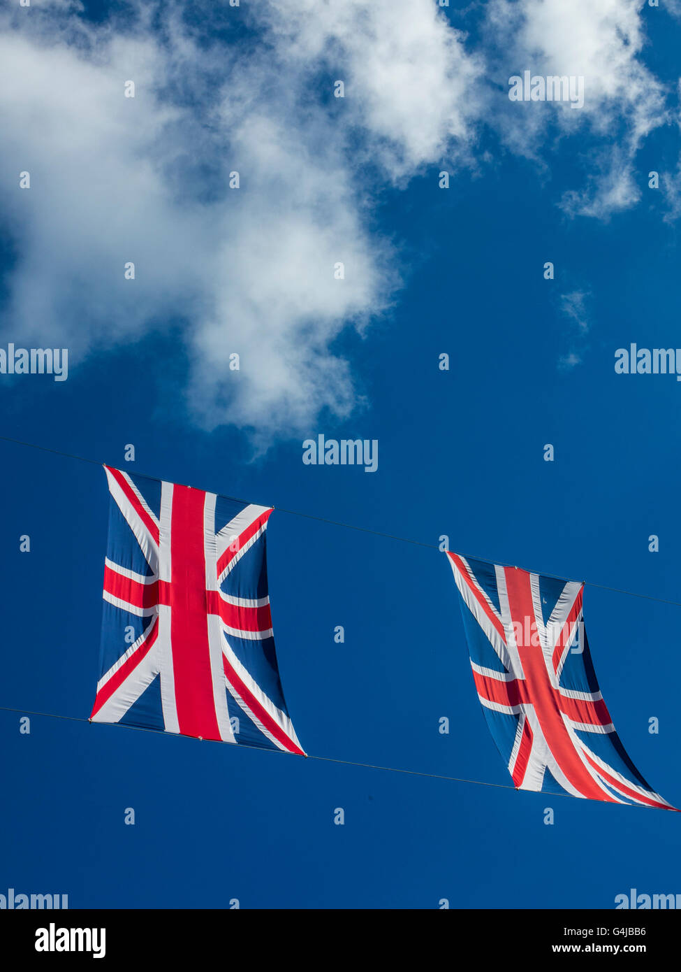 Union Jacks flags appear to float in a blue sky Stock Photo Alamy
