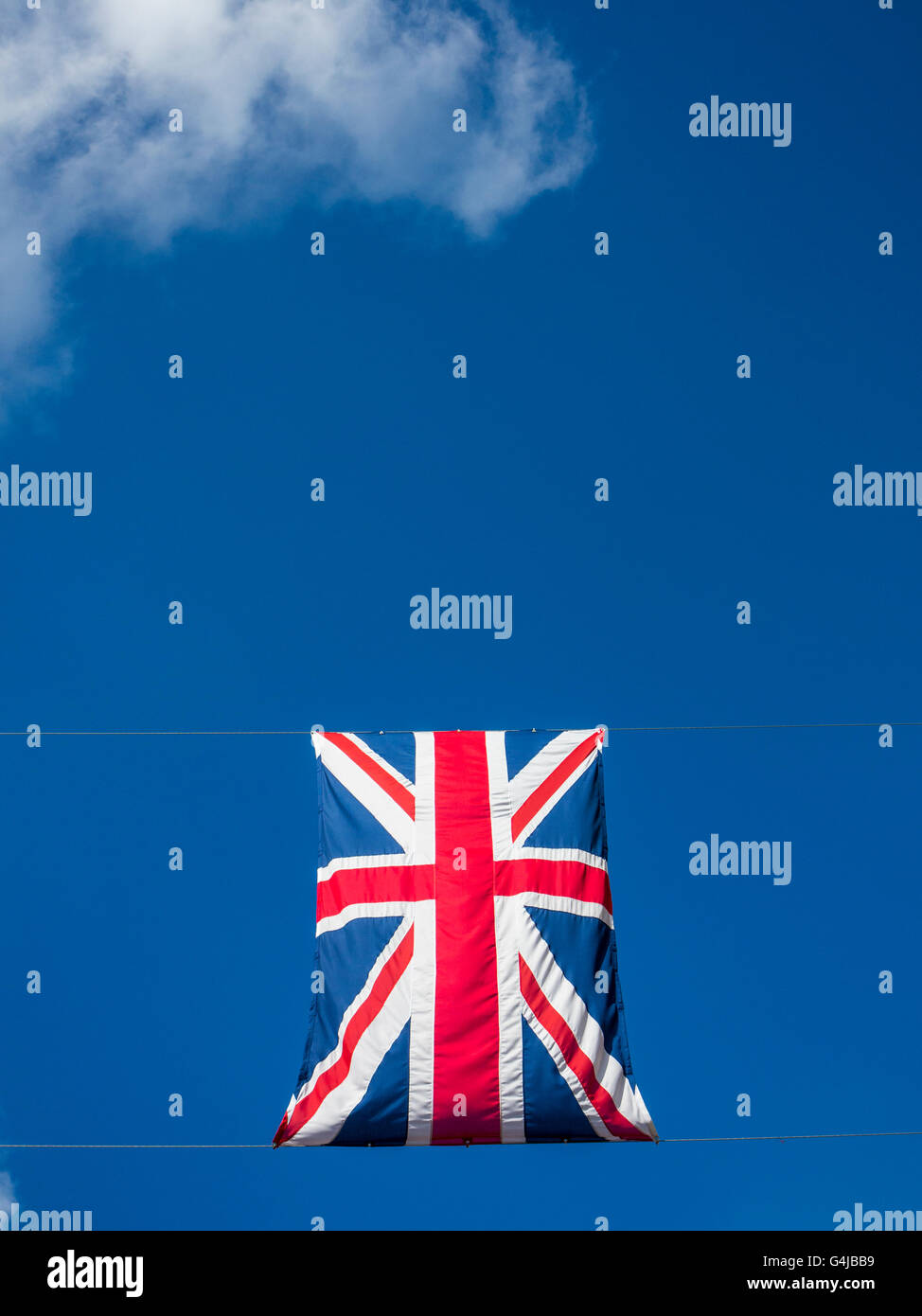 Union Jacks flags appear to float in a blude sky Stock Photo Alamy