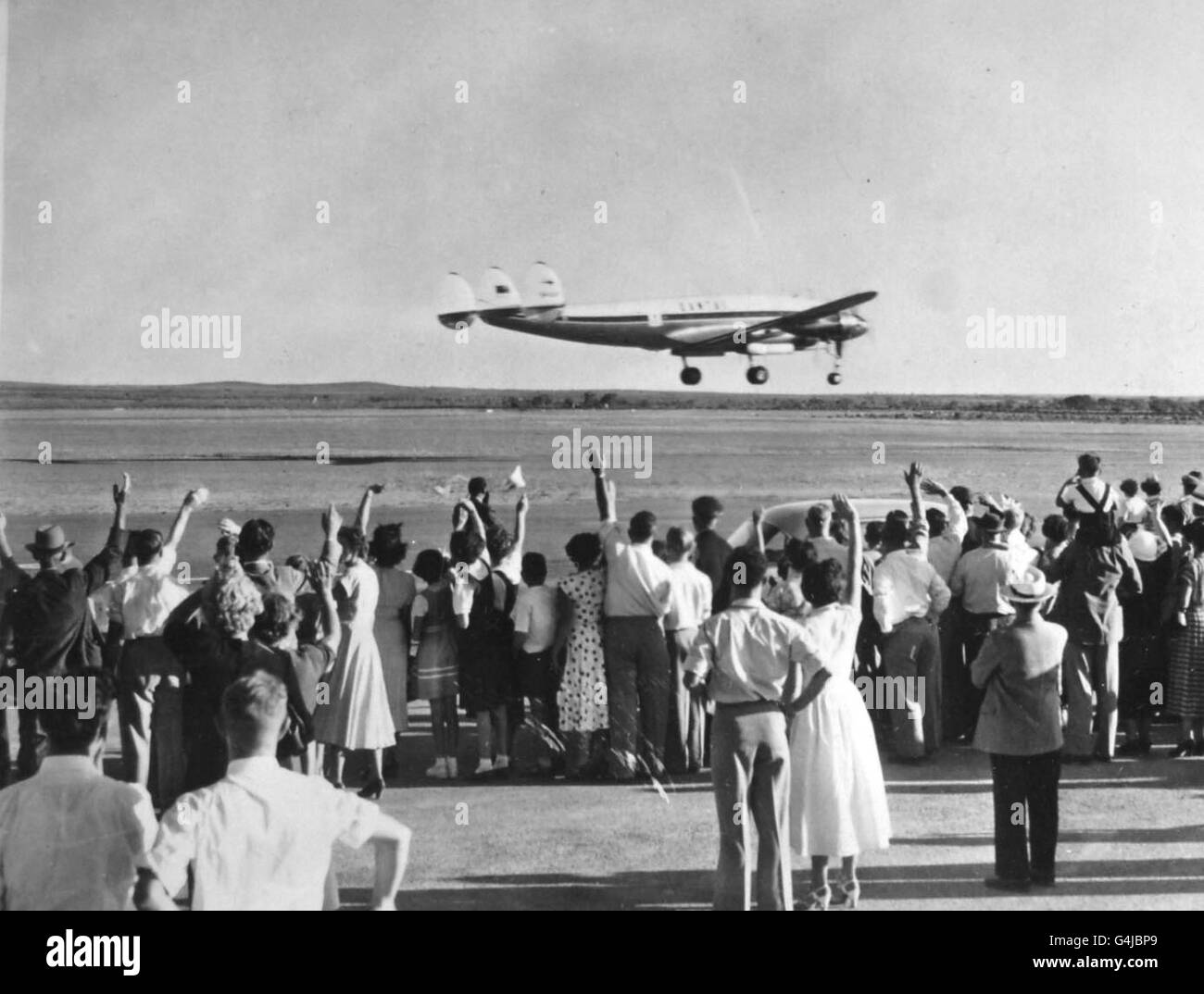 Crowds wave as the Royal aircraft takes off from Broken Hill, New South Wales, for the tour of Adelaide. Stock Photo