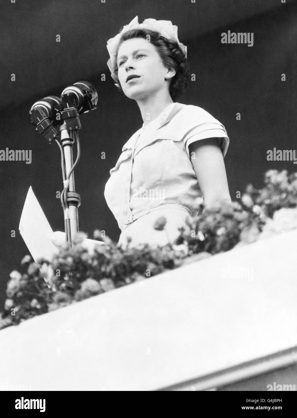 Queen Elizabeth II addresses the crowds from a dais in the Exhibition Ground, Brisbane. Stock Photo
