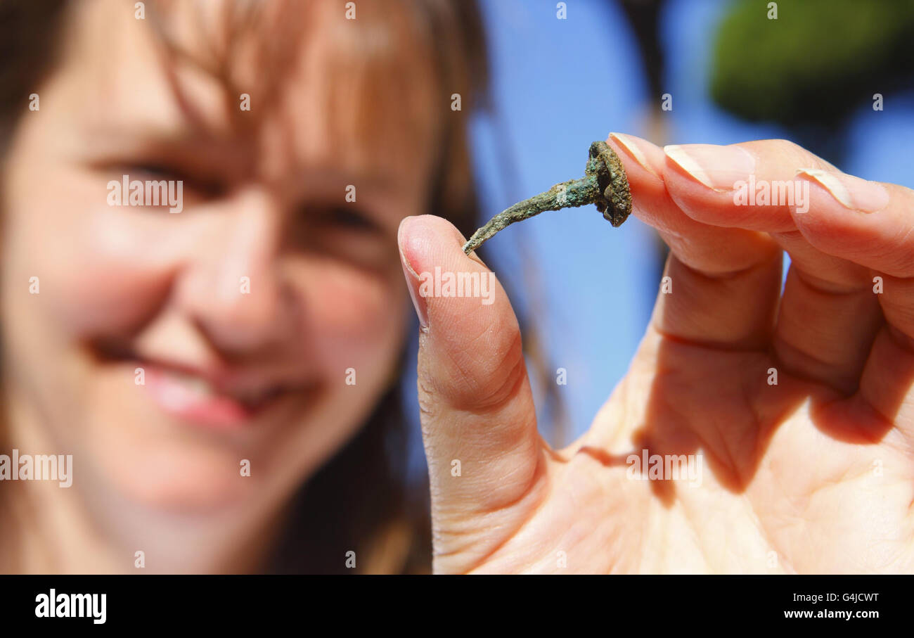 Penny Copeland, a researcher from the University of Southampton holds a copper tack used for shipbuilding at Portus, the ancient port of Rome in Italy where they have discovered a large building used for that purpose. Stock Photo