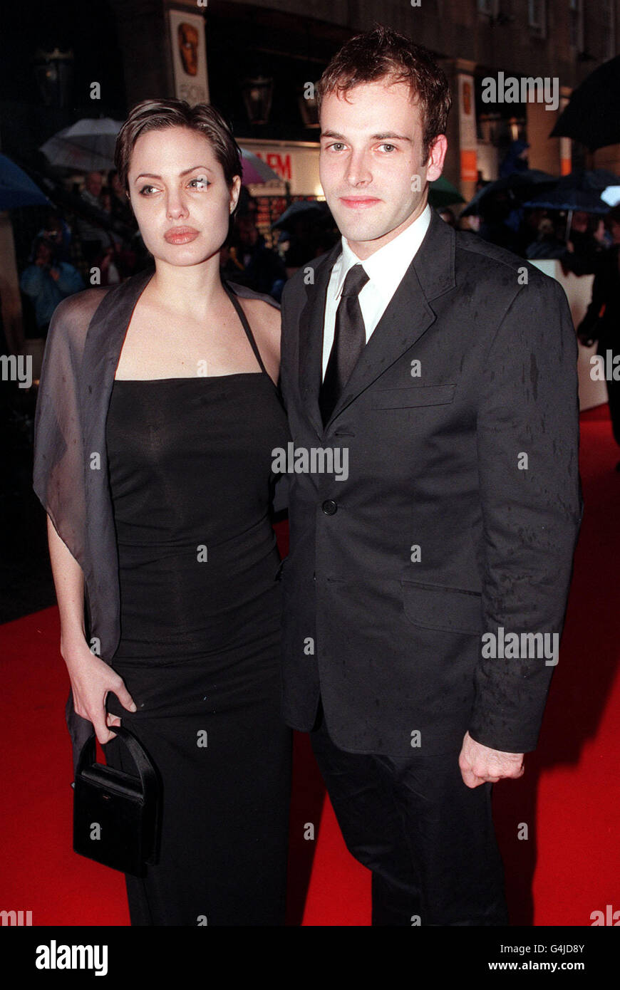 Actor Johnny Lee Miller with his wife actress Angelina Jolie at the BAFTA Awards at the Grosvenor House Hotel. Stock Photo