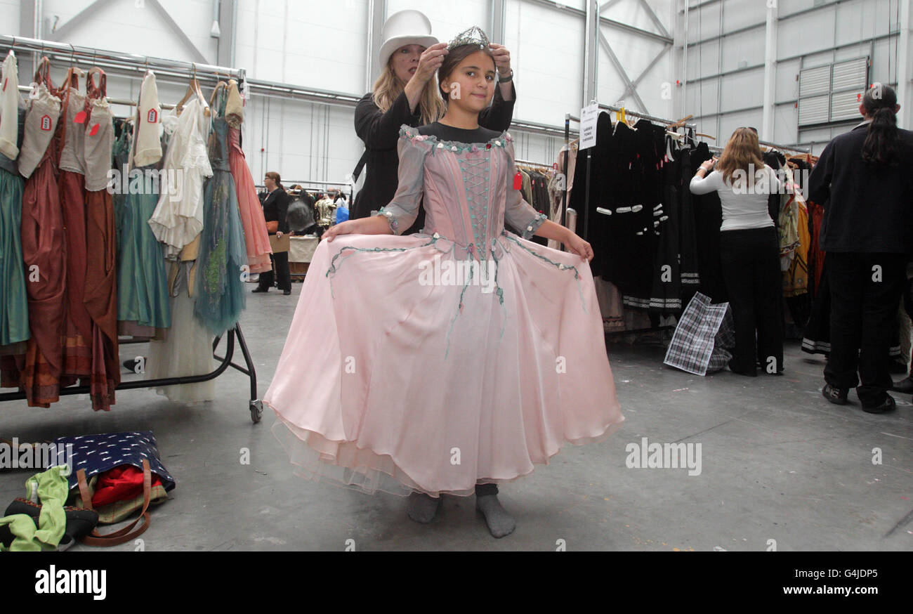 Mandy Komlosy with her daughter Katie, 11, trying on a dress from Sleeping Beauty during a costume sale from Royal Opera House productions in Purfleet, Essex. Stock Photo