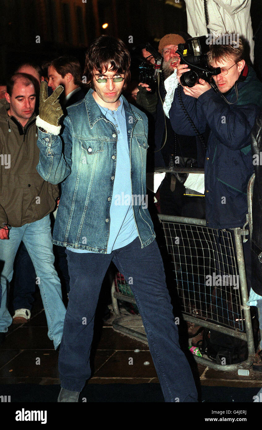 Liam Gallagher of Oasis gestures to the media as he arrives for the opening  of designer Tommy Hilfiger's new flagship store in London's New Bond Street  Stock Photo - Alamy