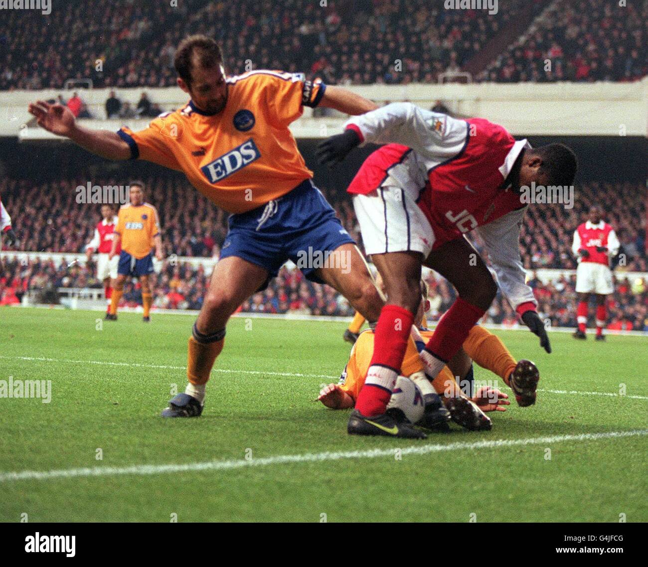 This picture may only be used within the cxontext of an editorial feature. Arsenal's Nwankwo Kanu fends off a challenge from Derby County's Igor Stimac (left), during their FA Cup quarter-finalmatch at Highbury. Arsenal defeated Derby 1-0. Stock Photo