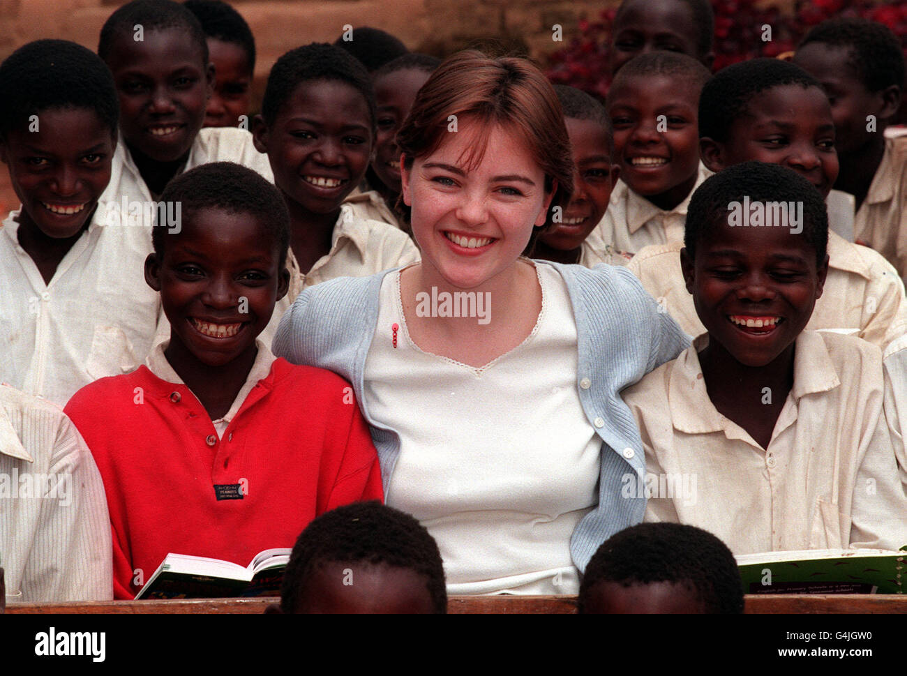 Melanie Clark Pullen (Mary in 'Eastenders') on a Christian Aid trip to Tanzania in East Africa, to highlight the Jubilee 2000 campaign to cancel Third World debt. Here she is seen with children at Lusala primary school, Ludewa district. Stock Photo